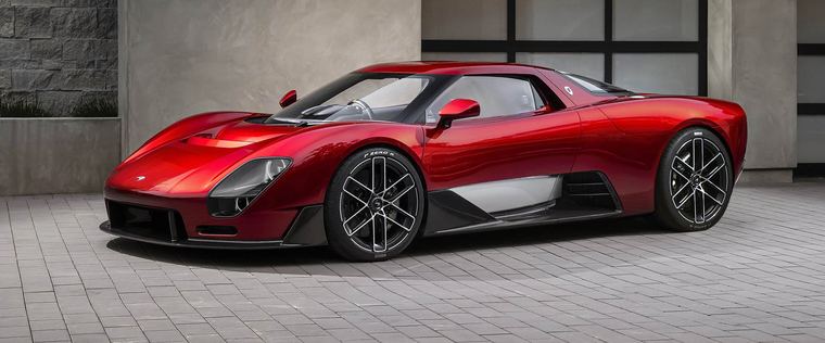 A red sports car in front of a building